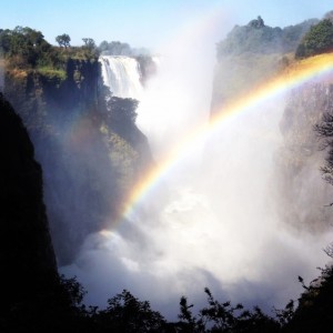 A rainbow shines over Victoria Falls in Zimbabwe