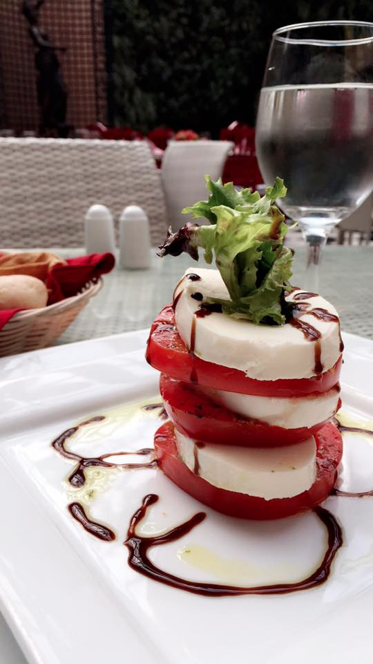 mozarella and tomatoes stacked with a balsamic glaze, know as caprese