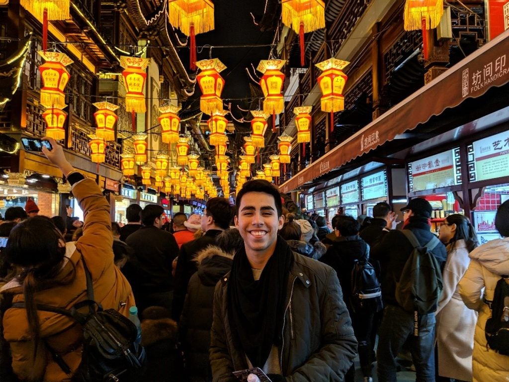 posing in a street market in China