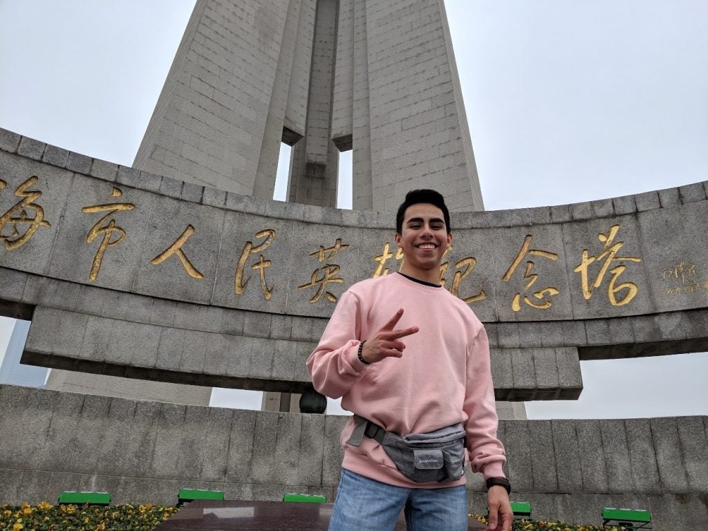 posing with fanny pack in front of statue