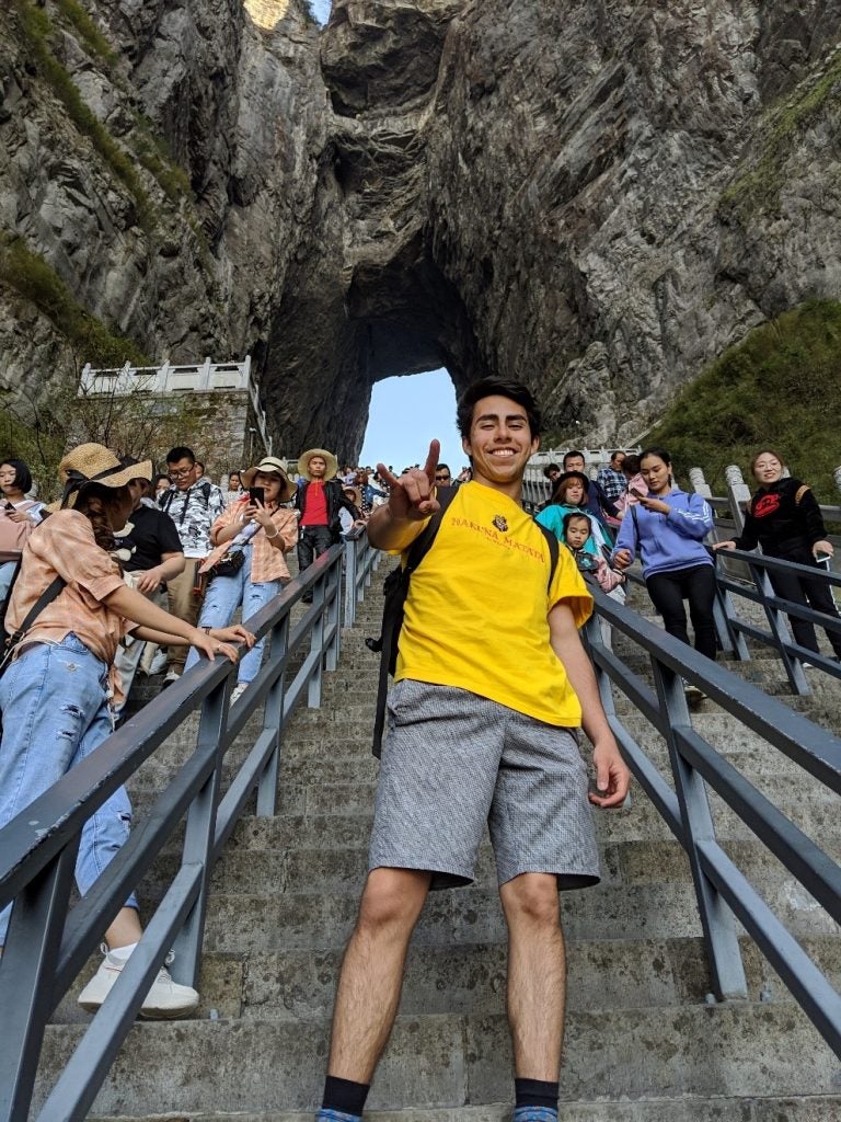 selfie in mountain tunnel showing off hook'em longhorn pride