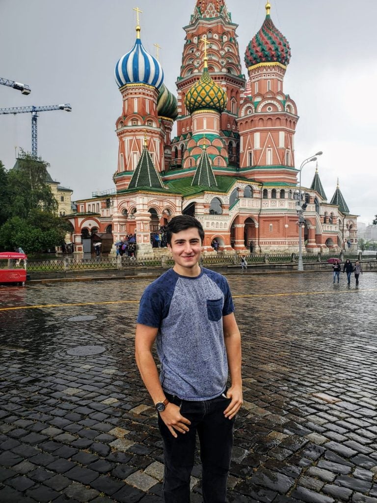 Standing in front of Saint Basil's Cathedral, an Orthodox church in Red Square of Moscow, and one of the most popular cultural symbols of Russia