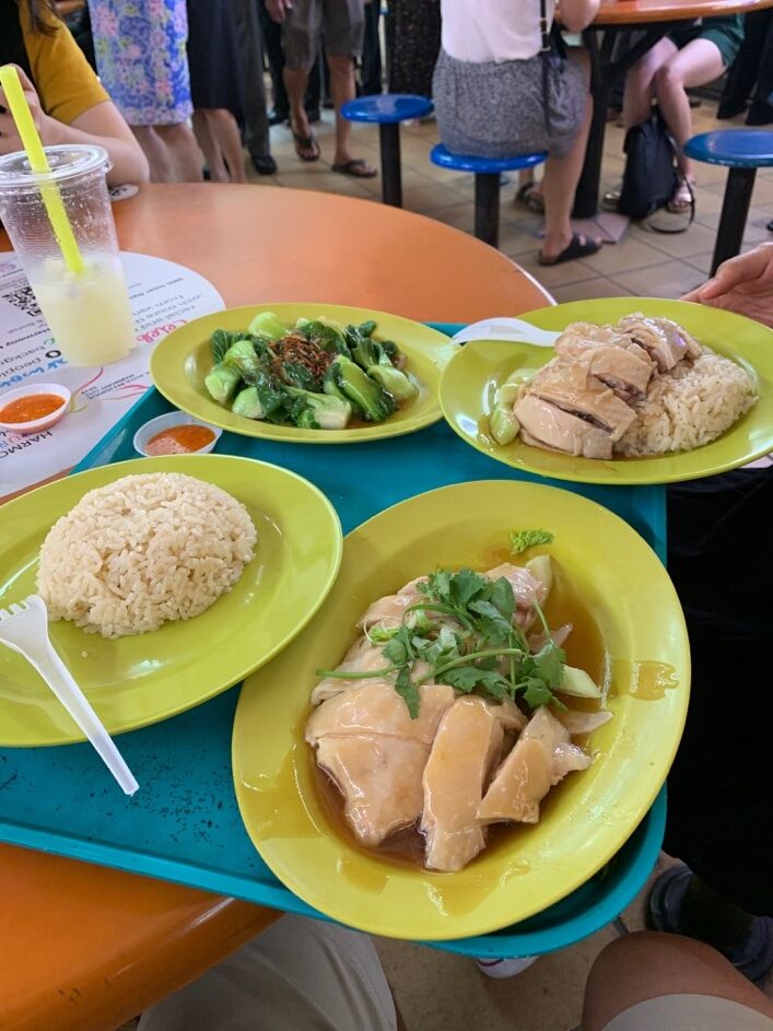 Eating Chicken Rice at Maxwell Hawker Centre. Many of the stalls in Singapore are cash only or have specific apps for Singaporeans only.