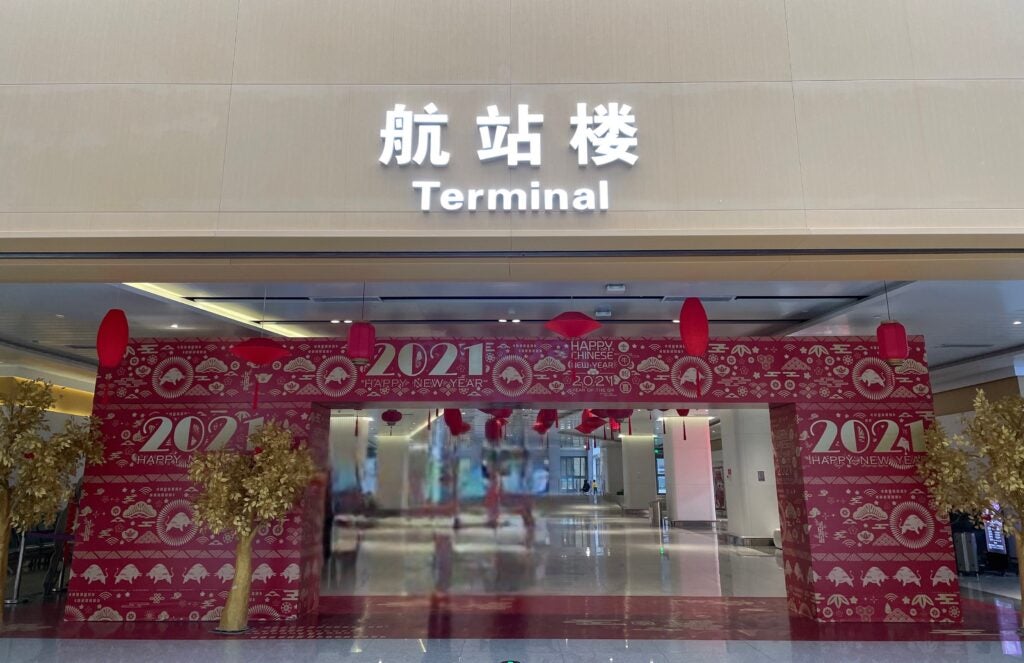 large red decorative archway in airport terminal