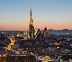 aerial view of large spire building in town at dusk