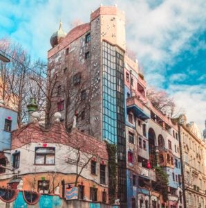 colourful buildings near trees under cloudy sky during daytime