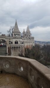 large historical site with turrets against cloudy sky