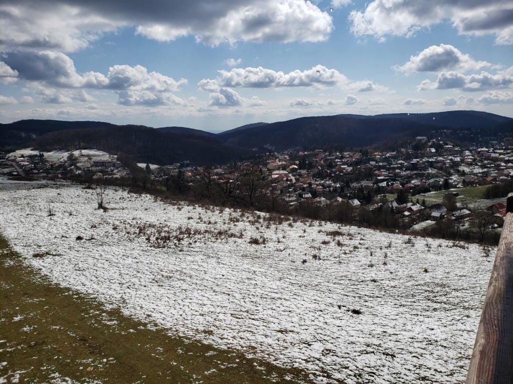 snowy field near hills during daytime