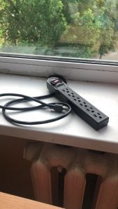 An extension cord on a windowsill.