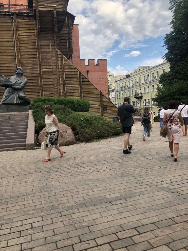 People walk outside the "Golden Gates of Kyiv Museum"