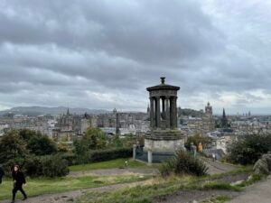 Grey clouds hover over an expanse of old stone buildings.