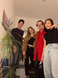 Jackie Smiles next to three of her flatmates