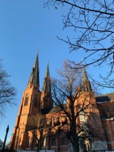 A upward shot of the Uppsala Cathedral framed by a blue sky