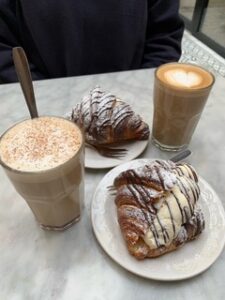 A photo of Anjali's breakfast featuring a Swedish coffee and croissant