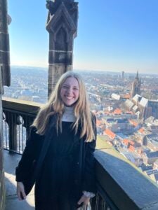 Katie Smiles in front of a church in Delft