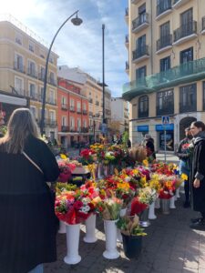 An image of flower arrangements being sold by a vendor on the street