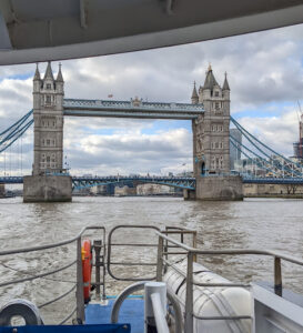 A picture of the Tower Bridge taken from a boat on the Thames river