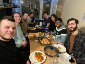 Anjali and her friends sit around a dinner table