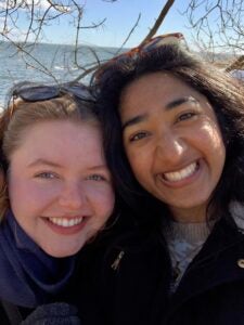 Anjali and her friend smile for a selfie