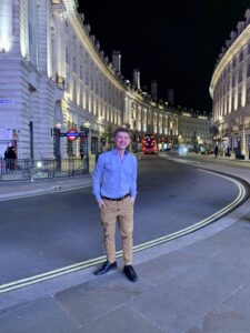 Global ambassador Devin Geelhoed standing in Piccadilly Circus