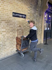 Global ambassador Devin Geelhoed in front of Harry Potter platform 9 3/4