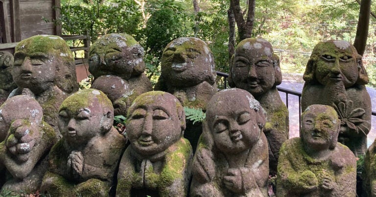 Moss covered stone statues at Otagi Nenbutsu-Ji Temple in Kyoto, Japan