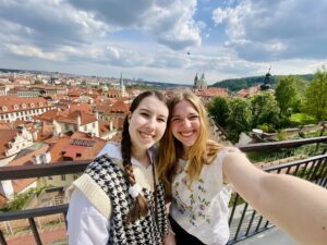 Katie Mulry and friend Sophie take selfie in front of a Prague, Czechia landscape.