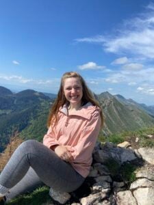 Katie Mulry posing in front of the Swiss Alps.