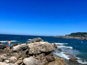 A view of the rocky coast of Spain. The deep blue water and sky compete for intensity.