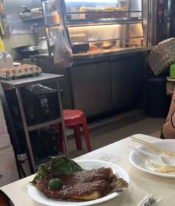 A piece of stingray is served in a banana leaf at a food court in Singapore