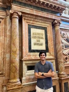 Anthony stands in front of marble archives