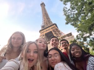 Gillian in friends take a selfie with the Eiffel Tower