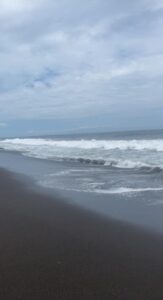 A beach in Guatemala with black sand from the volcano