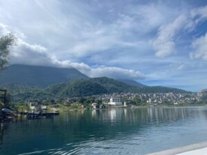 Houses and villages dot the lush mountainside, right next to Lake Atitlán