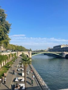 View of bicyclists and pedestrians enjoying a sunny day along the river Seine