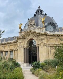 Old French building with dome and golden statues 