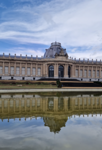 The Royal Museum for Central Africa is reflected off the water next to it
