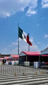 The Mexican flag waves over buildings