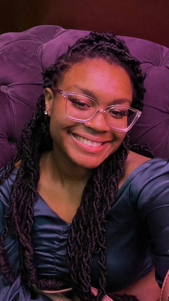 A selfie of a girl with purple lighting
