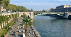 Bicyclists and pedestrians enjoy the road next to the river Seine in Parisr