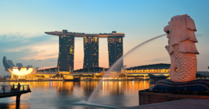 Three tall attached buildings in Singapore look over the bay
