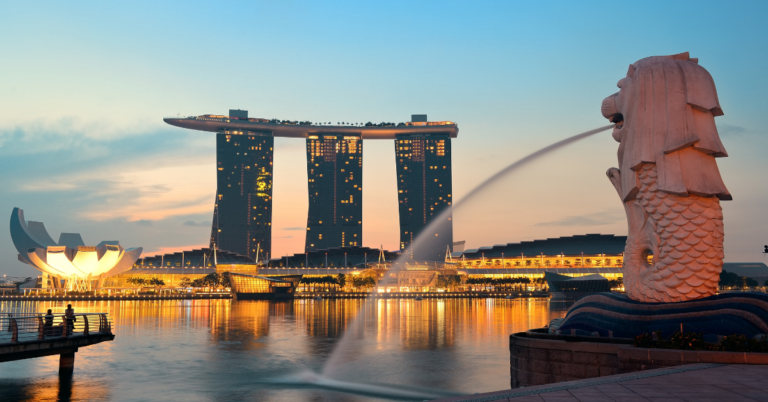 Three tall attached buildings in Singapore look over the bay