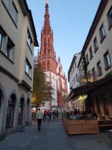 A red church sticks out between buildings in Würzburg