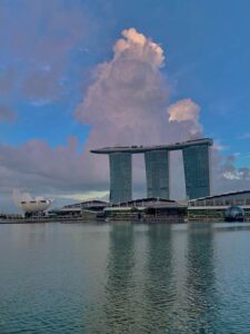 The Marina Bay Sands Hotel in Singapore is reflected in the bay in front of it