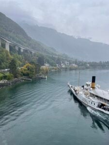 A foggy view of a lake with a boat resting in it