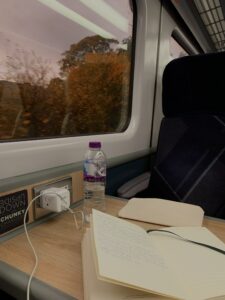 Gabby journals while taking the train to Stirling, Scotland
