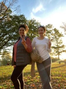 Standing outside on a crisp autumn day, Vanessa and family give the peace sign