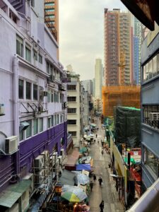 A shot of a street between buildings in tightly packed Central