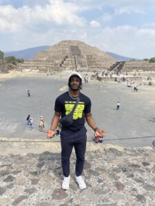 Male posting in front of a pyramid in Mexico