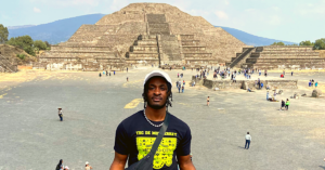 Student posing in front of a pyramid in Mexico